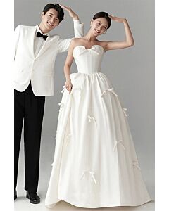 Whimsical Romance – Strapless Satin Ball Gown with Bow Embellishments