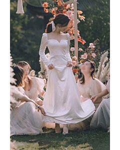 Graceful Long-Sleeve Wedding Dress with Heart-Shaped Neckline and Delicate Bow Detail