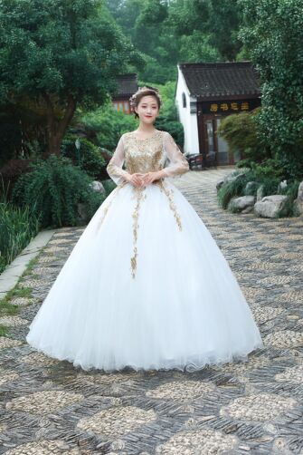 Golden Grace – White Tulle Ball Gown with Embroidered Bodice and Sheer Sleeves