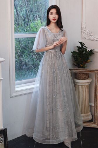 Soft V-neck, sheer tulle butterfly sleeves, sequin-embroidered bodice, and flowing A-line floor-length skirt