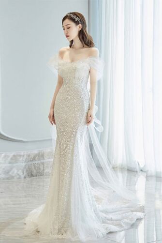 Elegant Off-Shoulder Silver Sequin Evening Gown with Flowing Train and Sheer Sleeve Detail