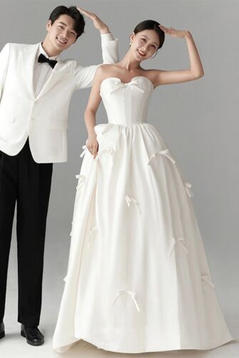 Whimsical Romance – Strapless Satin Ball Gown with Bow Embellishments