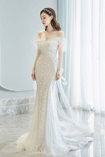Elegant Off-Shoulder Silver Sequin Evening Gown with Flowing Train and Sheer Sleeve Detail