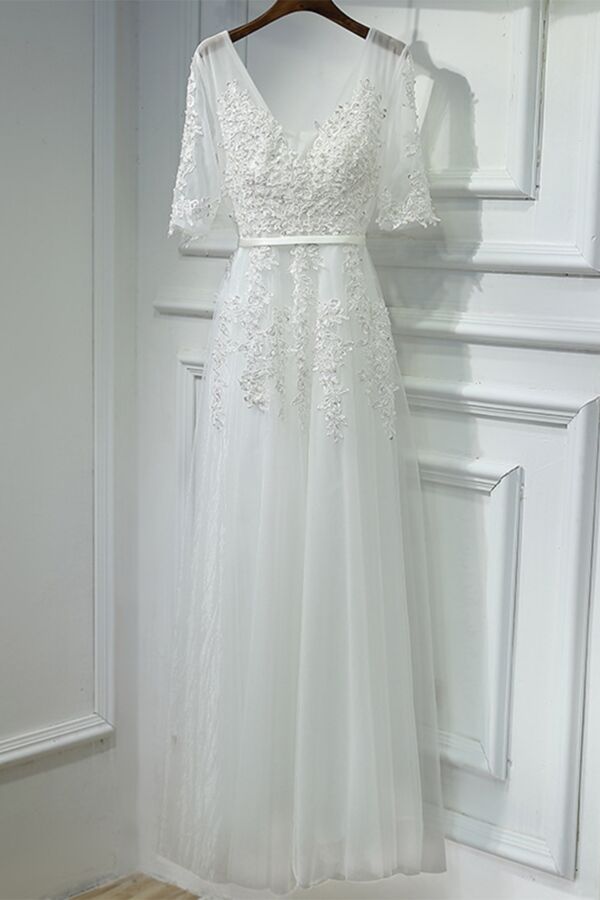 V-neck illusion bodice with floral lace appliqués that cascade past the waist.