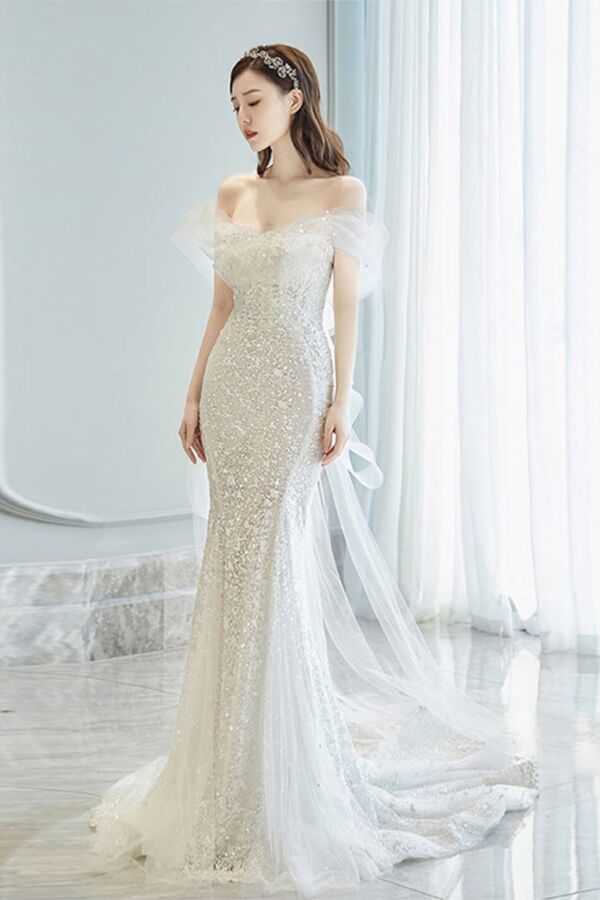 Elegant Off-Shoulder Silver Sequin Evening Gown with Flowing Train and Sheer Sleeve Detail